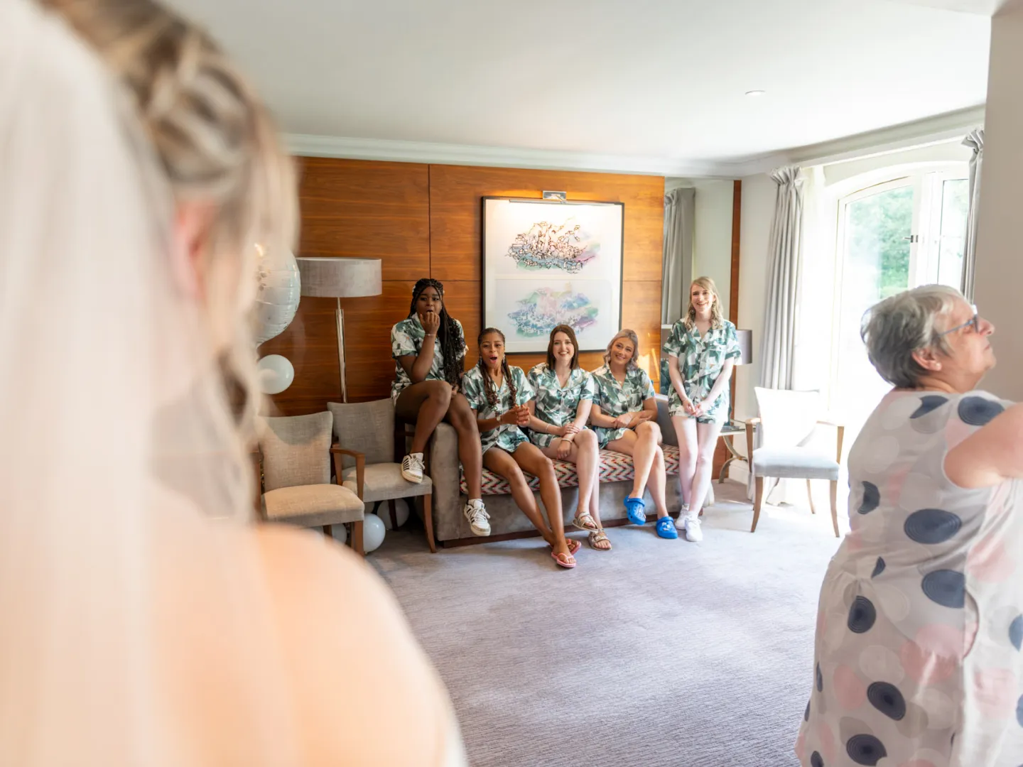 The bridesmaids seeing the dress for the first time