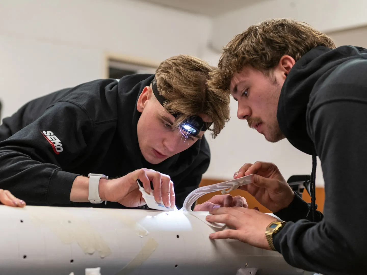 Two students working on rocket decals
