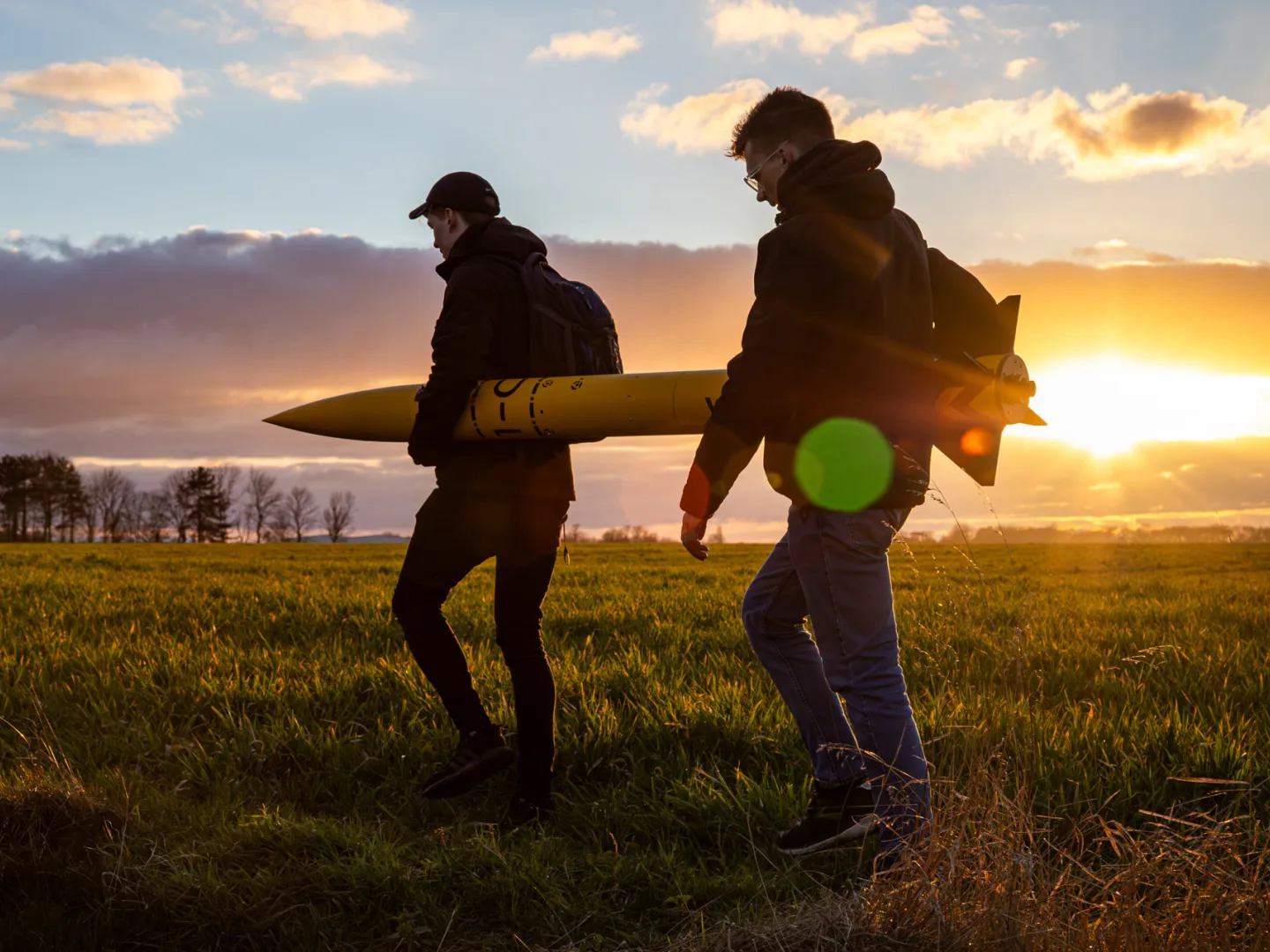 Leeds university rocket being carried at sunset