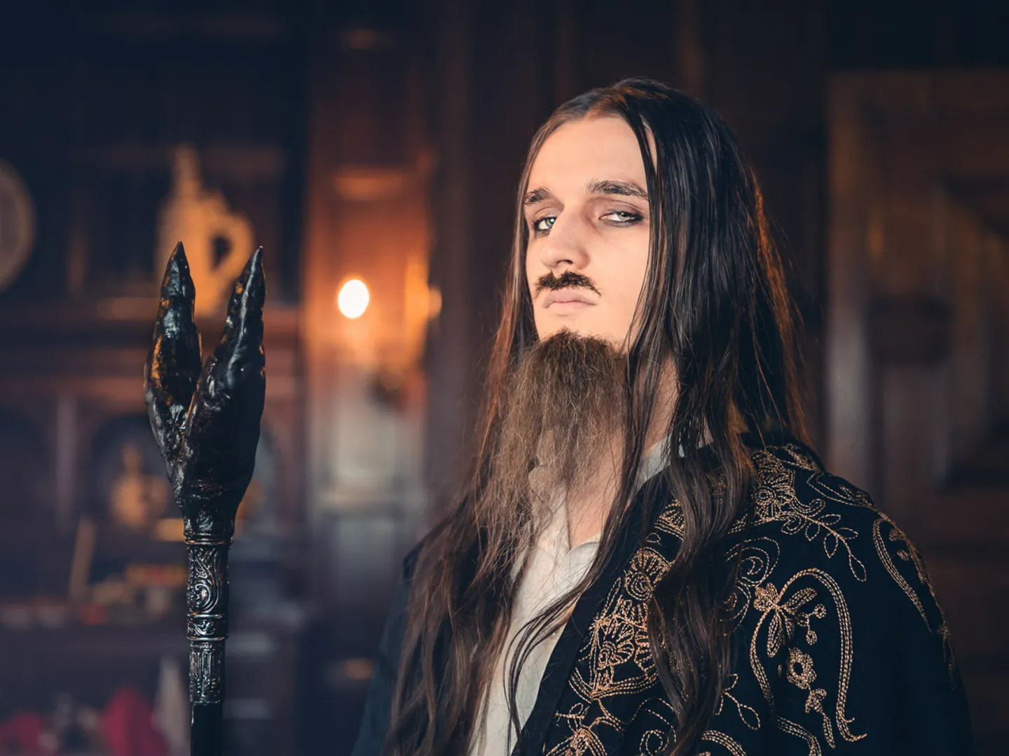 Man with long hair and a staff