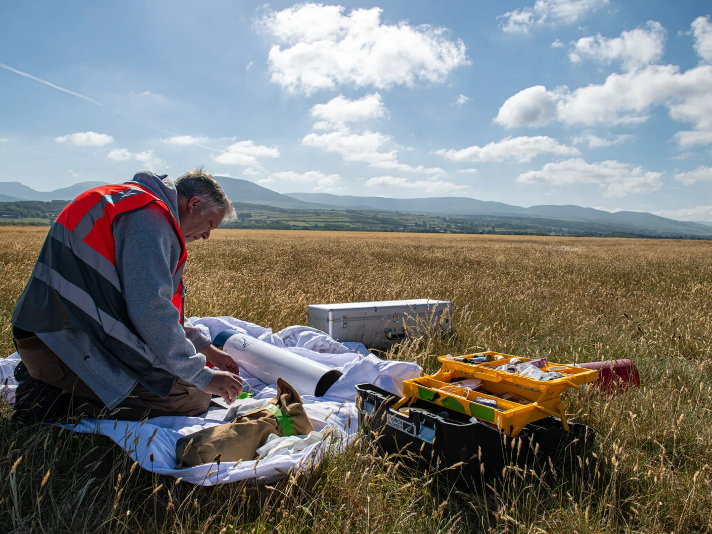 Launch access working on a rocket in a field
