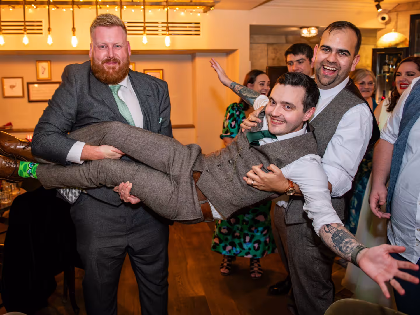 Best man carrying the grrom