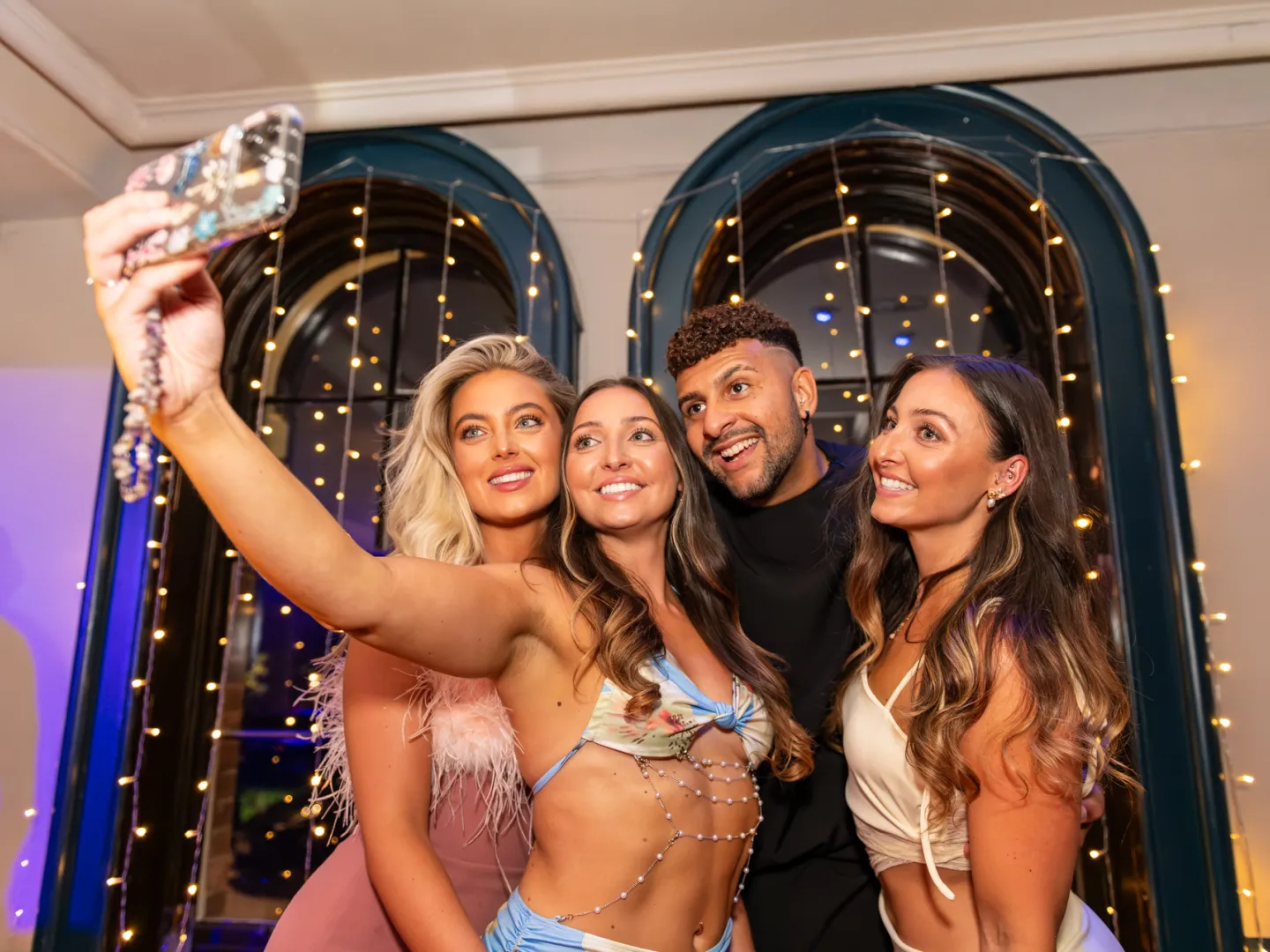 Theo Mayne birthday images while taking a selfie with guests