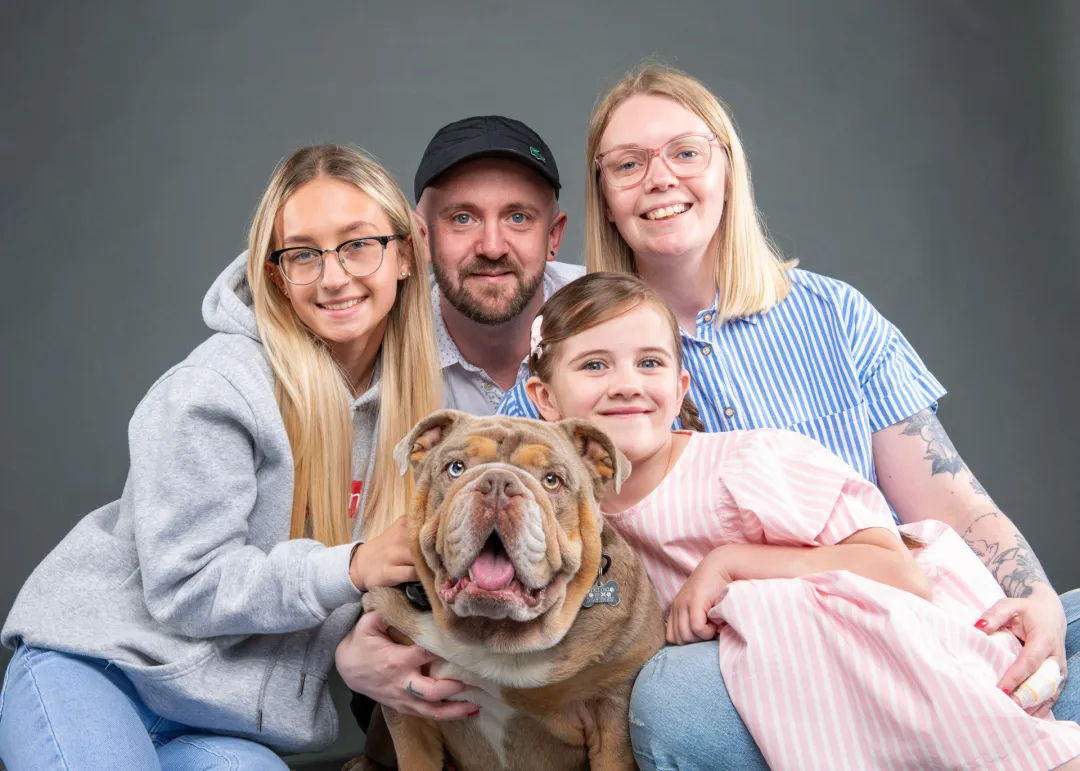 Family of four with their dog